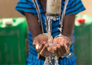 A child pouring water on his hands
