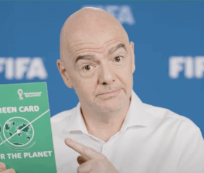 FIFA president Infantino with a green carbon-neutral card during 2022 World Cup