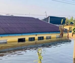 A file photo of a house submerged by flooding